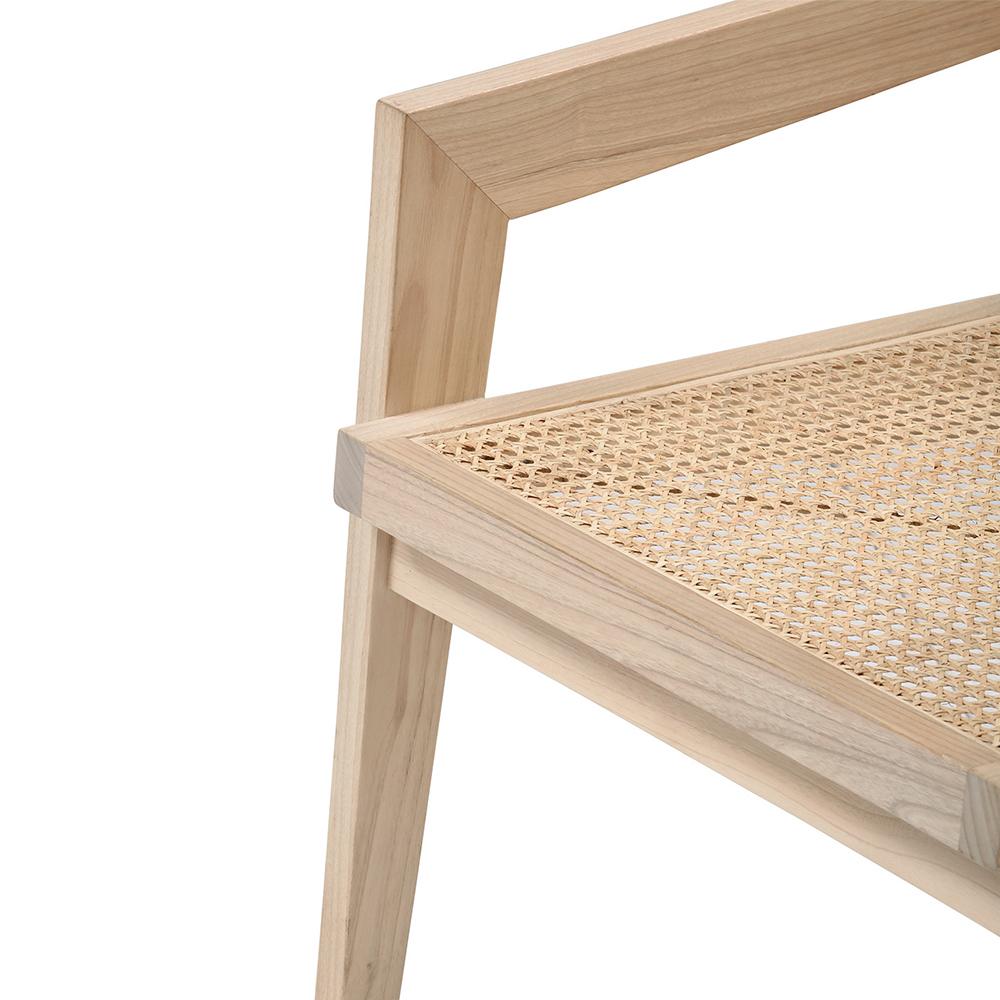 Natural rattan fauteuil chair named Pierre with a woven design, showcasing its stylish and comfortable seating.