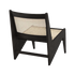 Black Rattan Kangaroo Chair called Pierre featuring a woven rattan design and a cozy, modern silhouette.