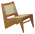 Brown rattan Kangaroo Chair named Pierre with a cozy, natural design, perfect for stylish living room or lounge decor.