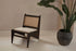 Dark brown rattan Kangaroo Chair with upholstered seat named Pierre, featuring a stylish, cozy design for living room decor.
