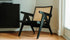 Black rattan lounge chair named Pierre with a modern design, perfect for stylish indoor or outdoor seating.