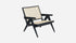 Black rattan lounge chair named Pierre with a modern design, featuring a sturdy frame and comfortable seating.