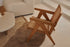 Brown rattan lounge chair named Pierre with a modern design, featuring a comfortable seat and sturdy frame.