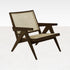 Dark brown rattan lounge chair named Pierre with a modern design, featuring a comfortable seat and stylish armrests.