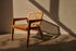 Dark brown rattan lounge chair named Pierre with a modern design, perfect for indoor or outdoor relaxation.