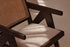 Dark brown rattan lounge chair with upholstered seat named Pierre, stylish and comfortable for indoor or outdoor relaxation.
