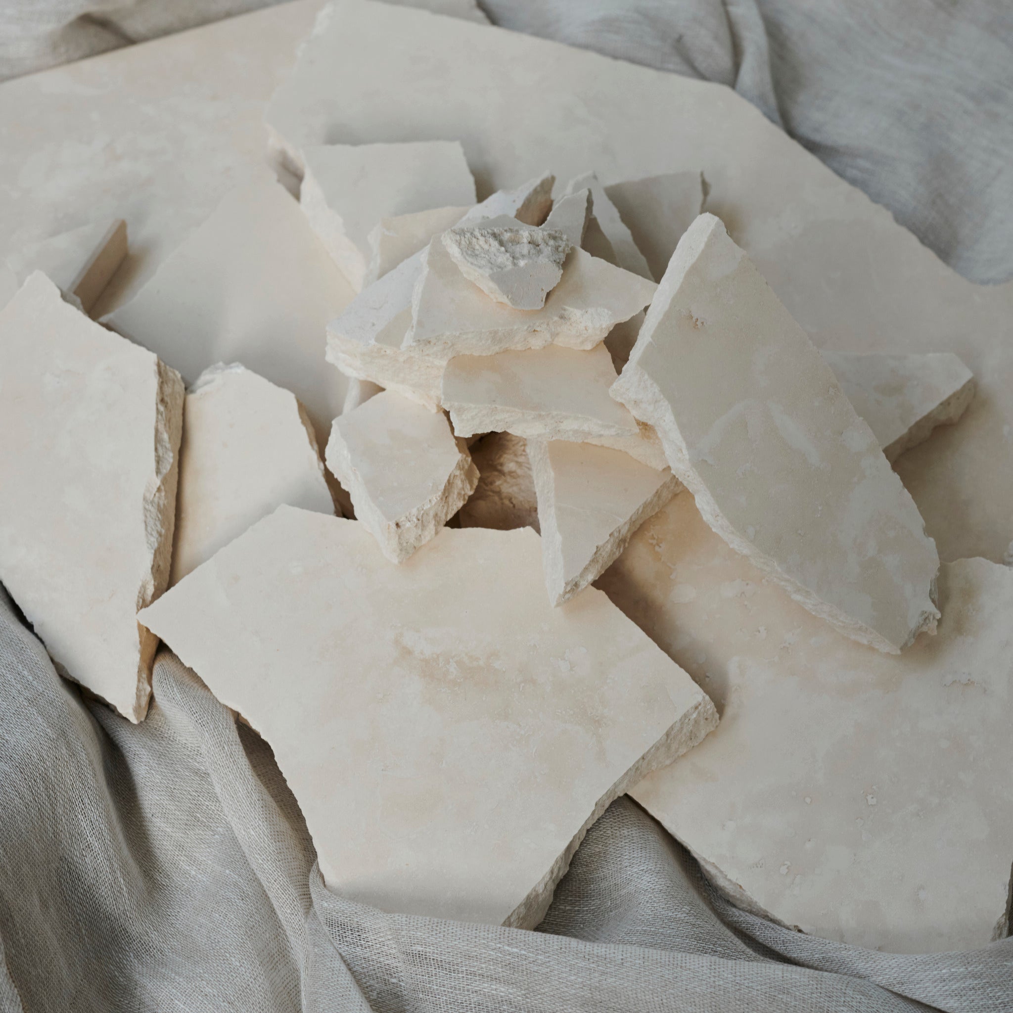 Sample travertine tile from My Store showing beige, textured stone surface with natural veining and porous finish.