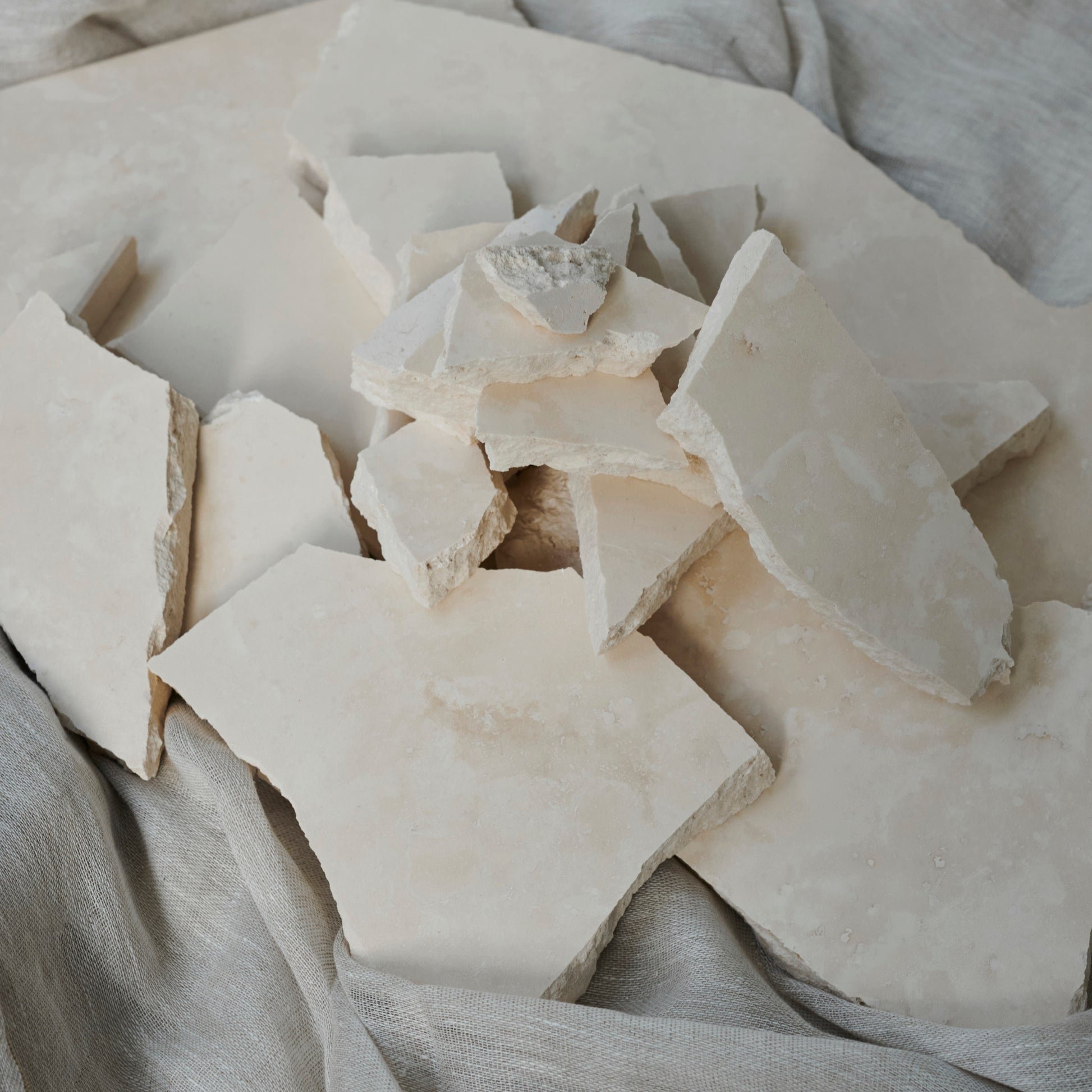 Sample travertine tile from My Store showing beige, textured stone surface with natural veining and porous finish.