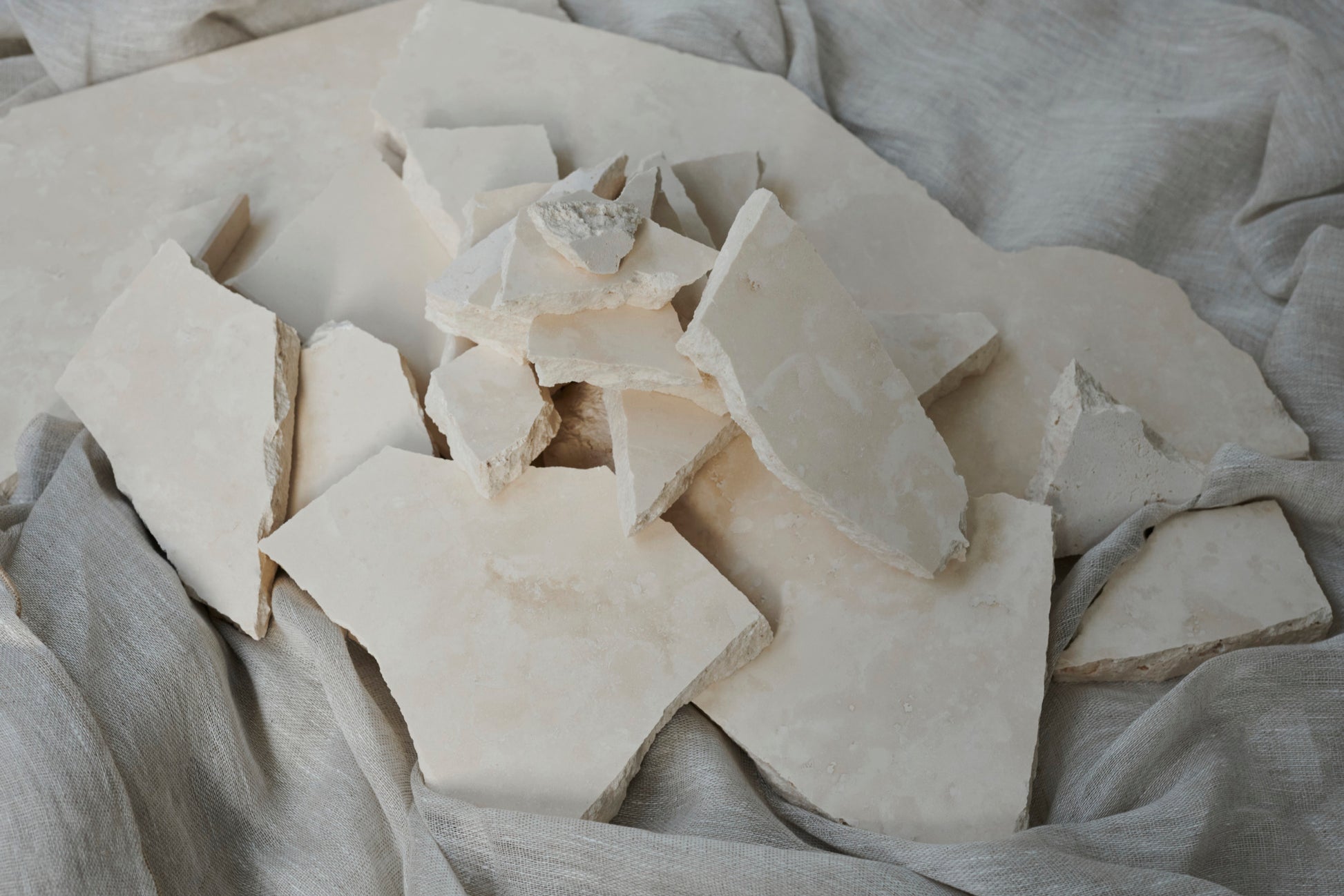 Sample travertine tile from My Store showing natural beige stone with textured surface and subtle veining.