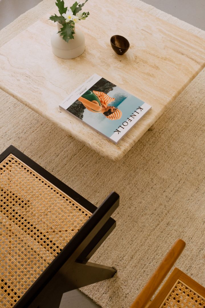 Travertine coffee table with a sleek rectangular design and natural stone surface, showcased in a modern living room setting.