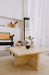 Elegant travertine coffee table with a smooth surface and sturdy base, perfect for modern living room decor.