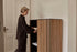 Brown oak ZINIA Cabinet by My Store with sleek wood finish and modern design, featuring multiple storage compartments.