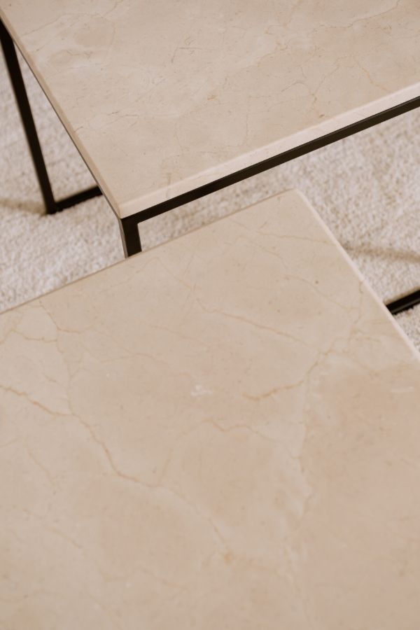 Creamy beige Crema Marfil marble coffee table set with glossy finish, featuring elegant design and smooth surface.