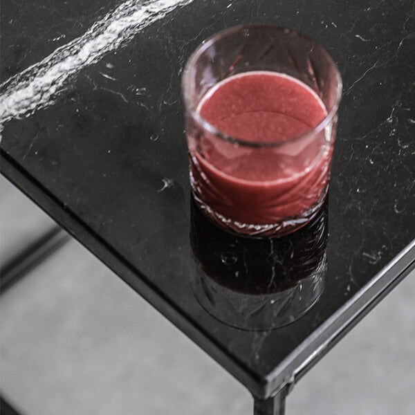 Glossy Nero Marquina black marble side table with sleek, modern design, featuring a smooth surface and sturdy base.