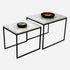 Set of two glossy Bianco Carrara white marble side tables with sleek, modern design and round tops.