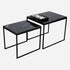 Set of two Nero Marquina black marble side tables with glossy finish, modern design and sleek round surfaces.