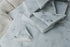 Glossy sample of Carrara Bianco marble showcasing white and gray veining, from My Store.