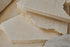 Glossy sample of Crema Marfil marble from My Store, showcasing warm beige tones and smooth polished surface.