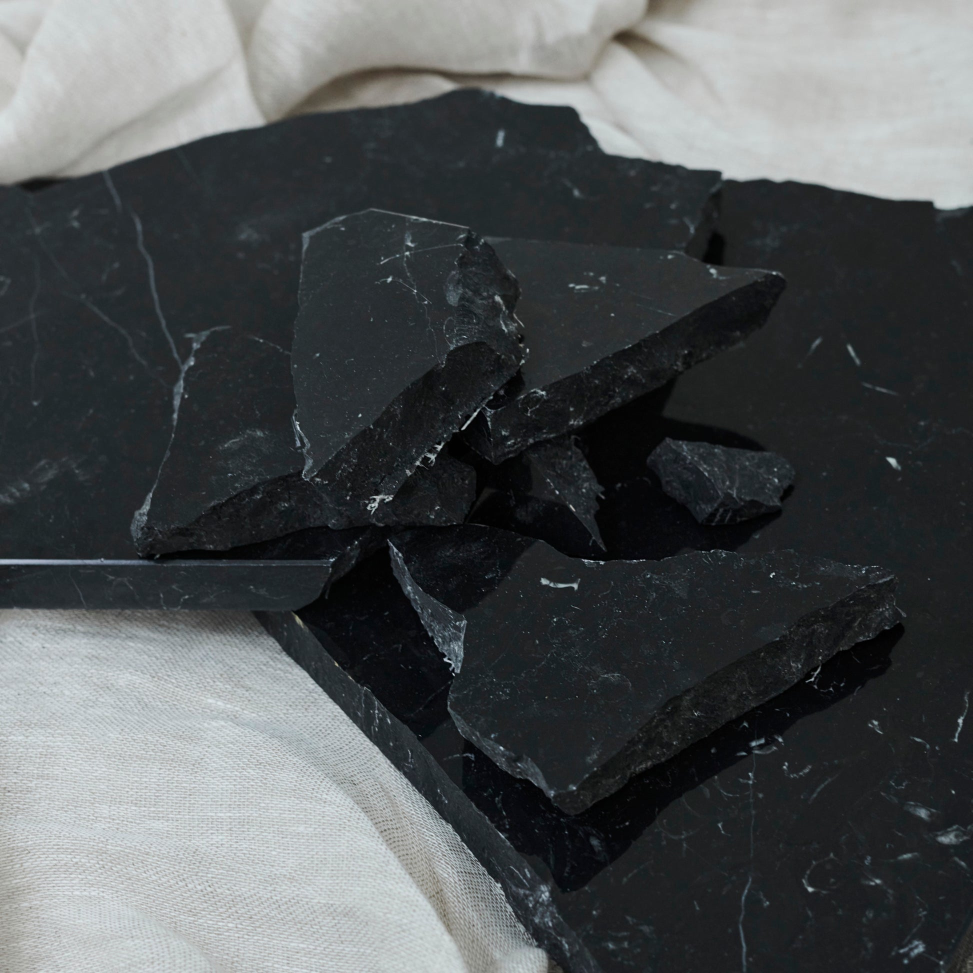 Glossy Nero Marquina marble sample from My Store showing deep black surface with white veining and polished finish.
