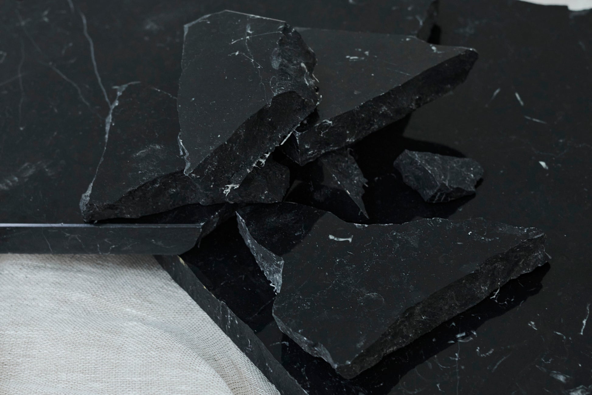 Glossy Nero Marquina marble sample from My Store, showcasing deep black surface with white veining for luxury interior design.