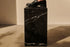 Black Nero Marquina marble cube with matte finish, showcasing elegant natural veining and smooth surface.