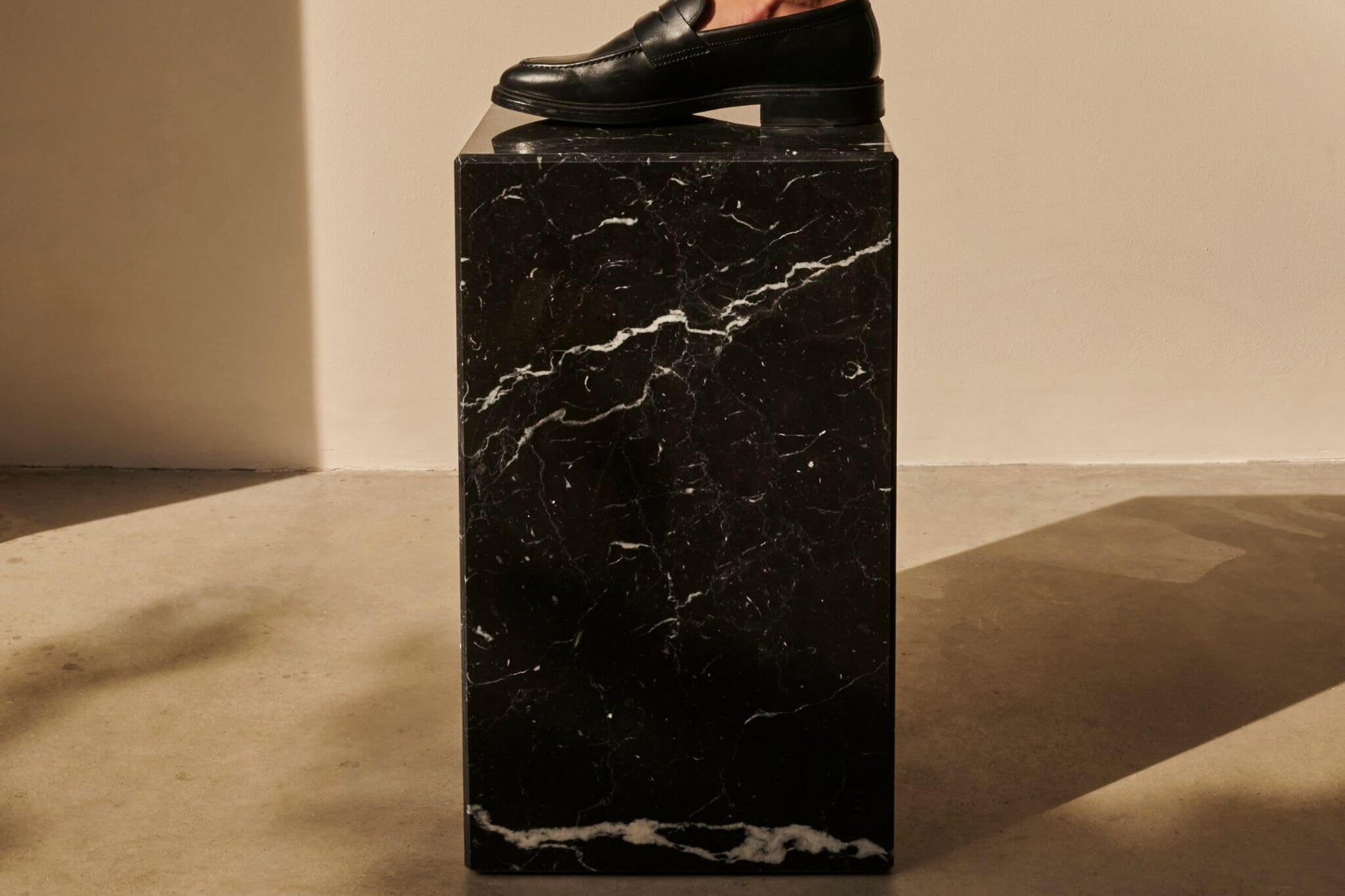 Black Nero Marquina marble cube with matte finish, showcasing elegant natural veining and smooth surface.