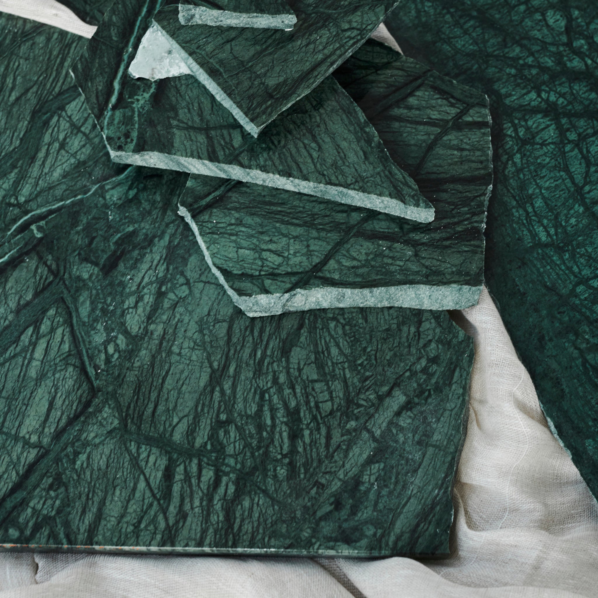 Sample India Green marble tile with matte finish, showcasing lush green and white veining for elegant interior surfaces.