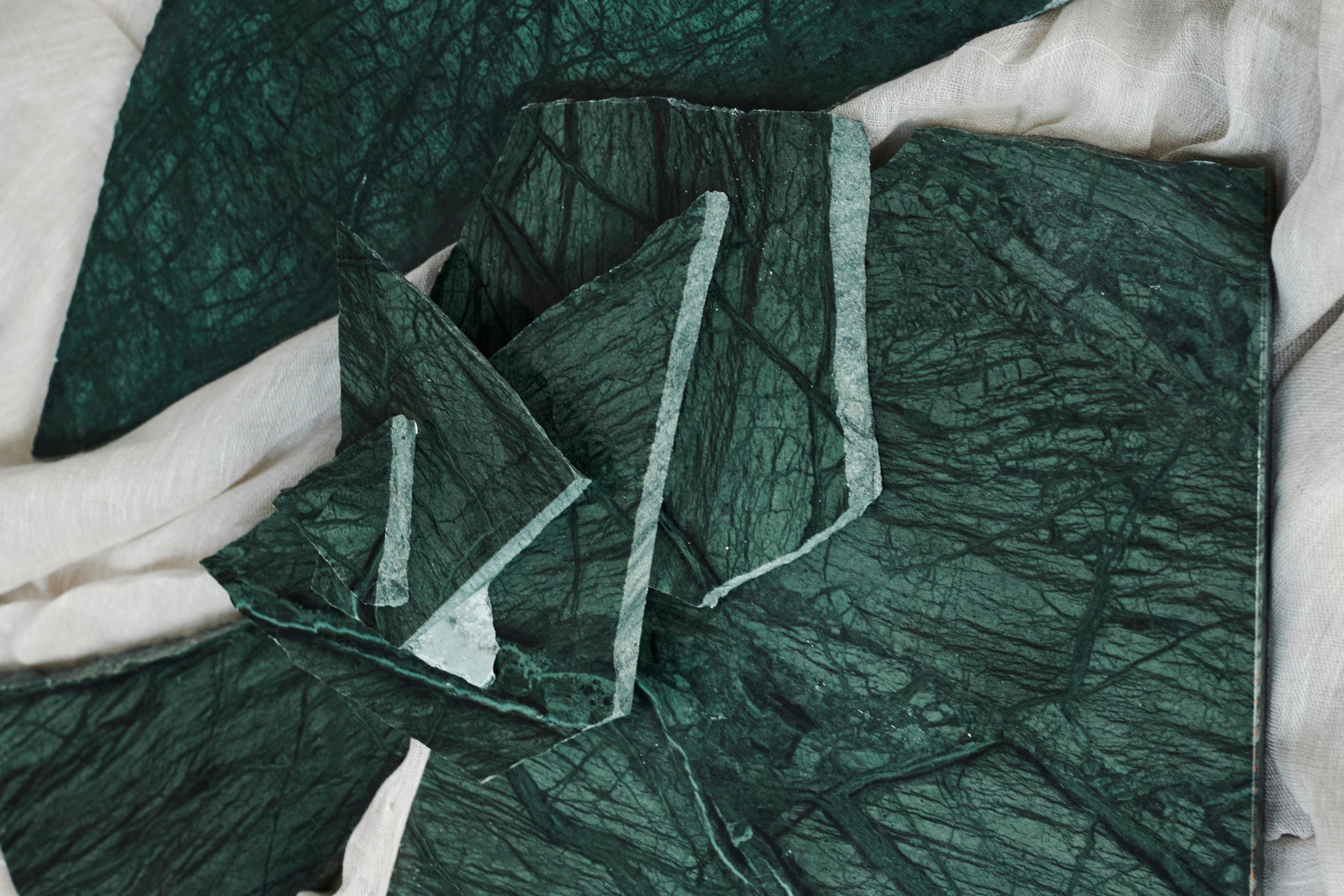 Sample India Green marble tile with matte finish, showcasing rich green and white veining for interior design or flooring.