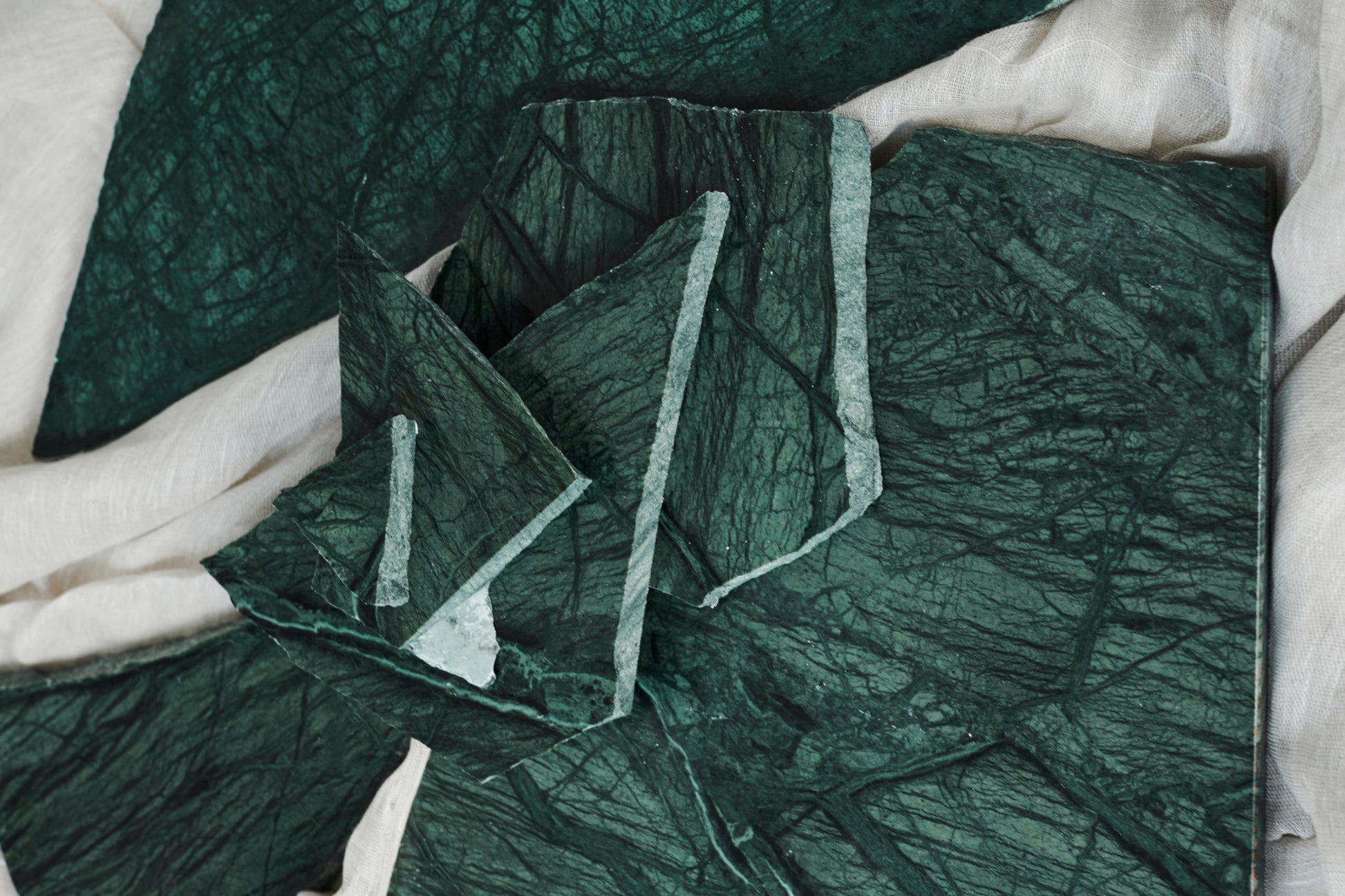 Sample India Green marble tile with matte finish, showcasing rich green and white veining for interior design or flooring.