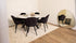 Round marble dining table with Bianco Carrara white surface and arch metal frame, modern and glossy design.