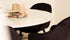 Round marble dining table with Bianco Carrara white marble top and arch metal frame for modern dining spaces.