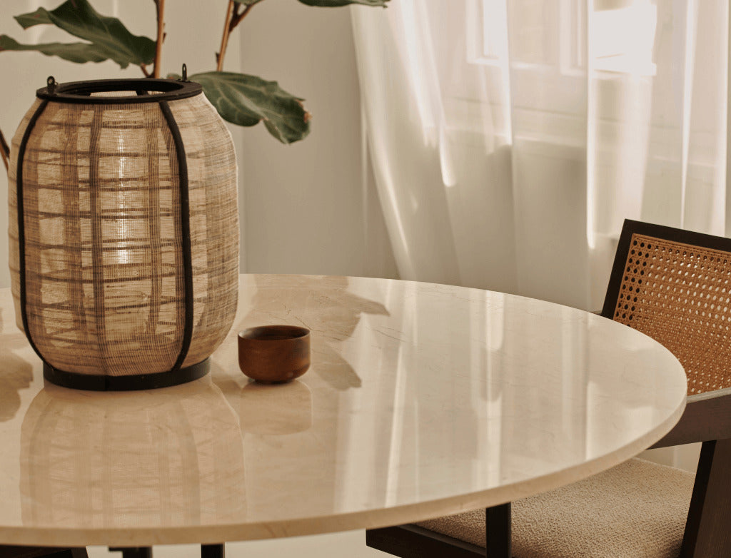 Round Crema Marfil beige marble dining table with cross-frame base, glossy finish, ideal for modern dining rooms.