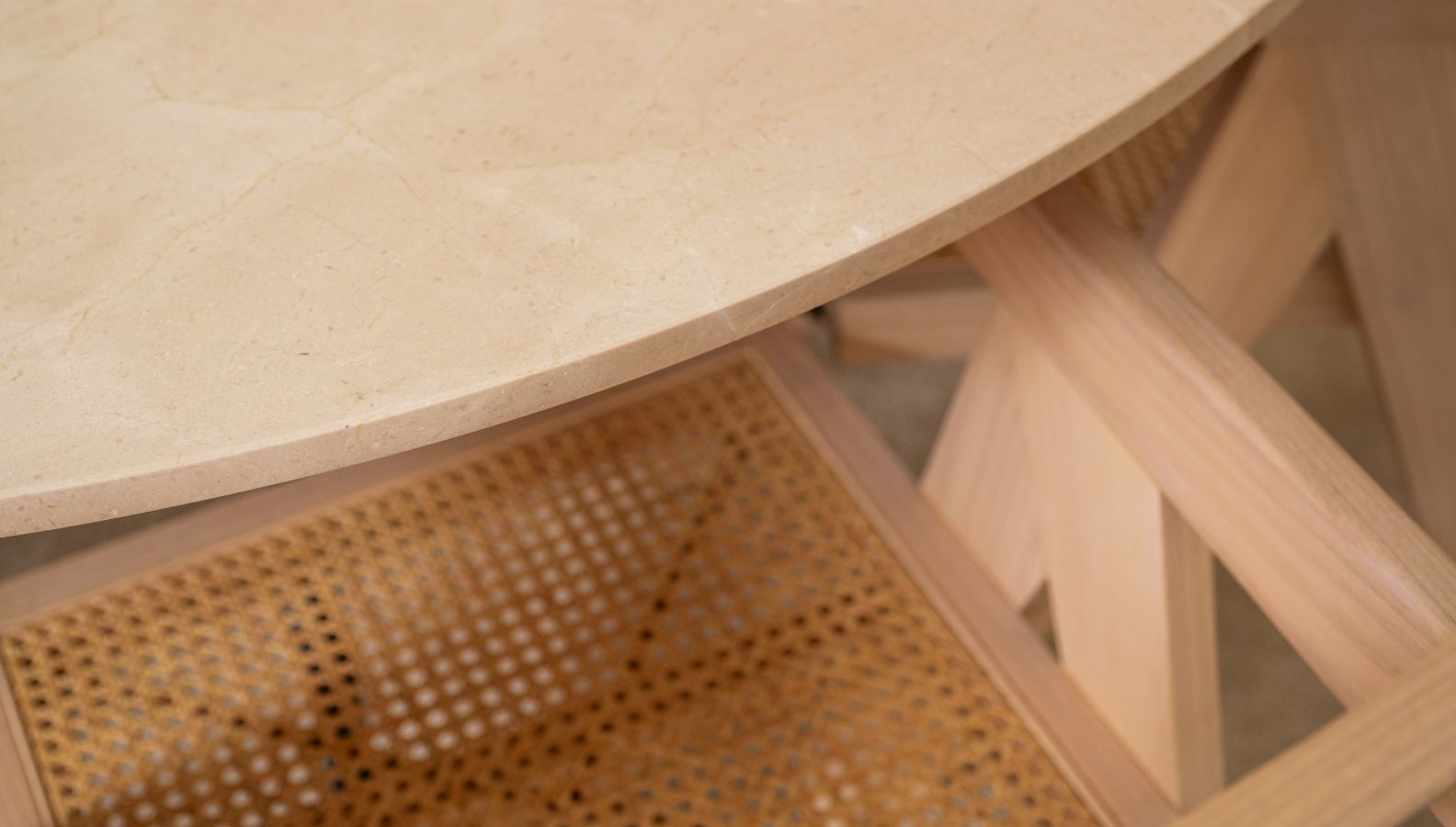 Round Crema Marfil beige marble dining table with cross-frame base, glossy finish, from My Store.