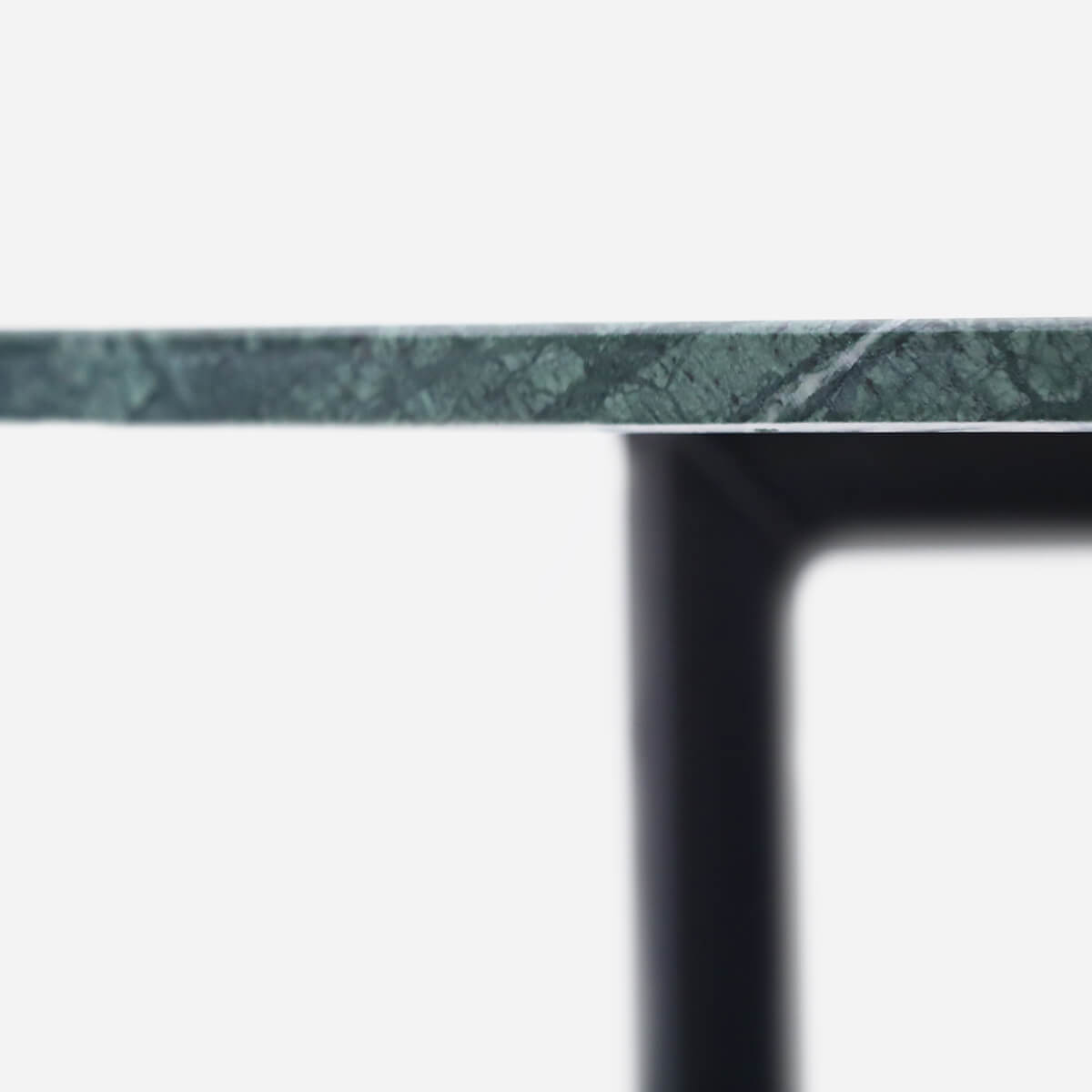Round India Green marble dining table with glossy finish and cross-frame base, perfect for modern dining rooms.