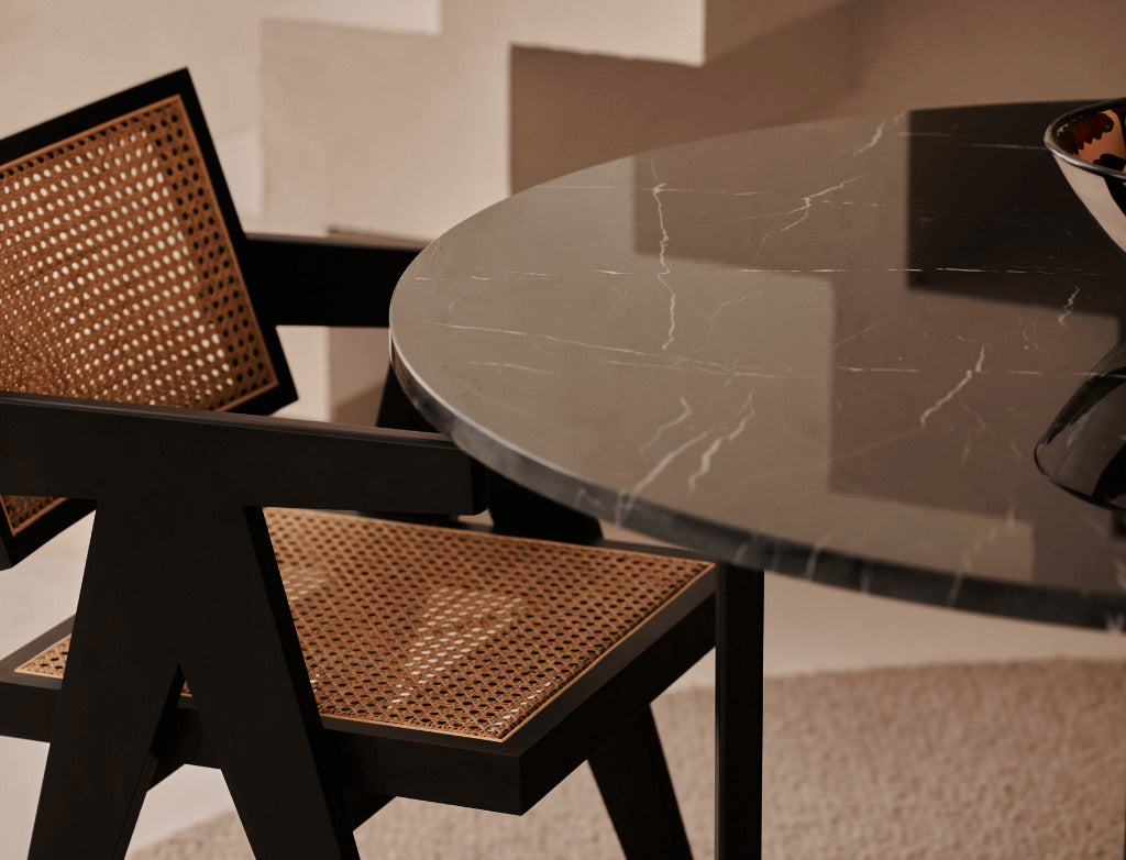 Glossy black Nero Marquina marble round dining table with cross-frame base, modern design, perfect for contemporary dining rooms.