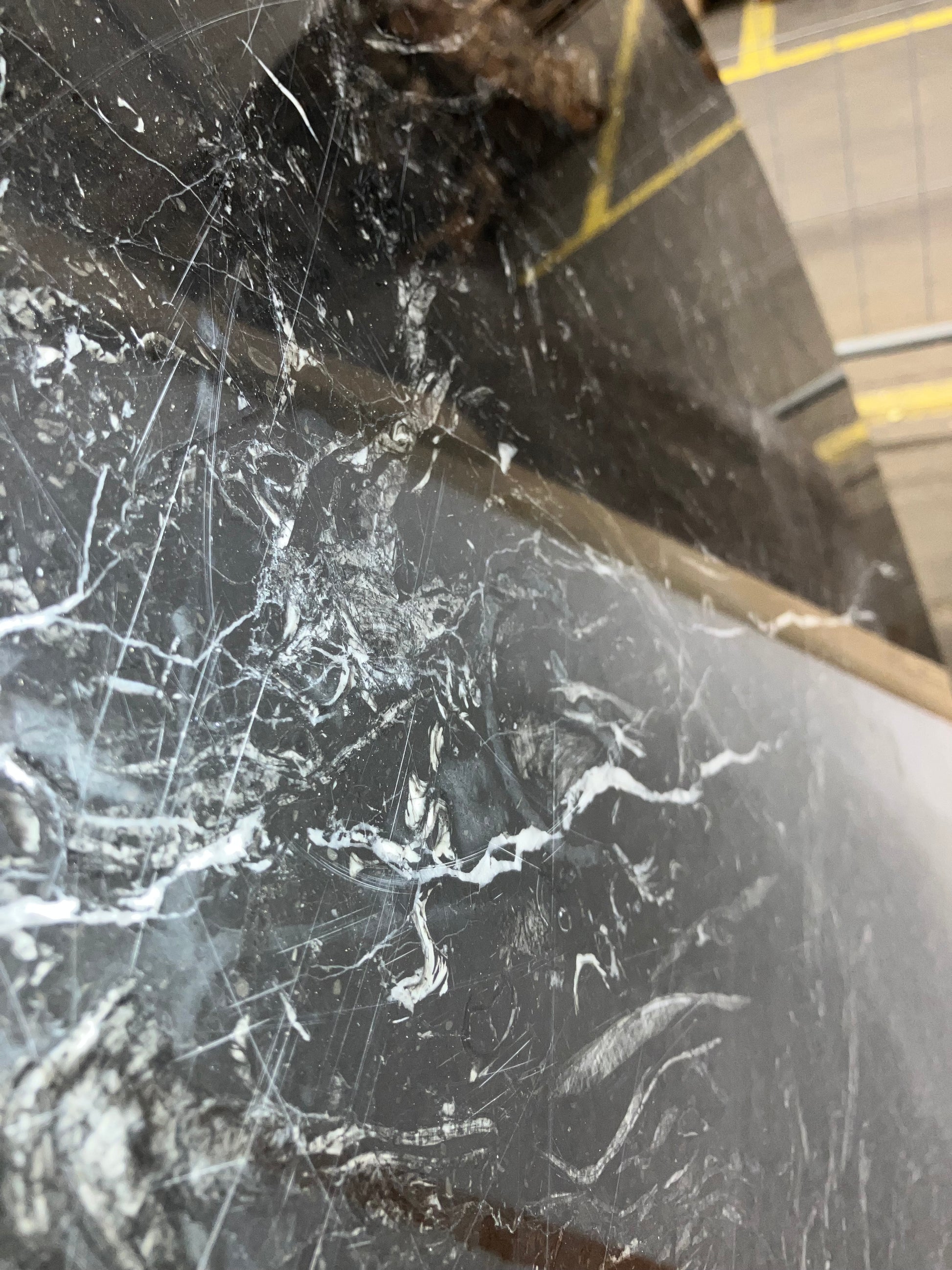 KIYO round dining table with Nero Marquina black marble top, 110 cm diameter, glossy finish with minor scratches and stains.