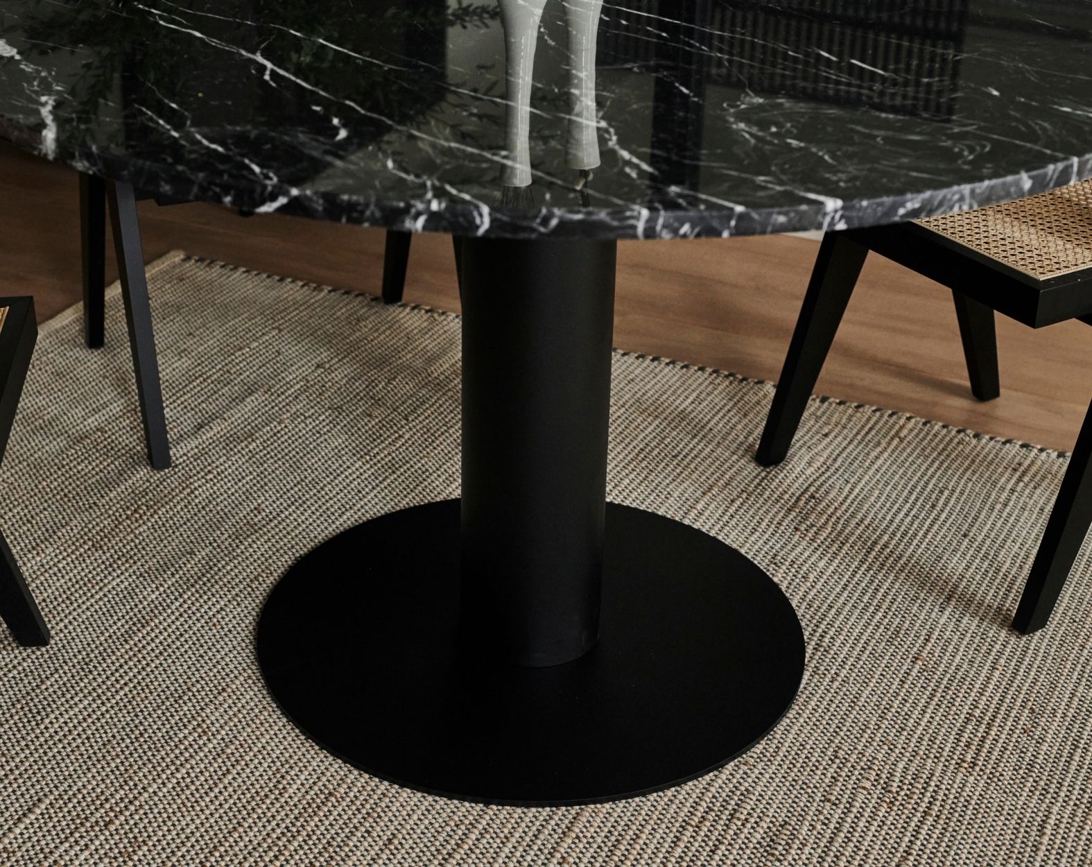 KIYO round dining table in Nero Marquina black marble with black center-leg, matte finish, minor surface scratches visible