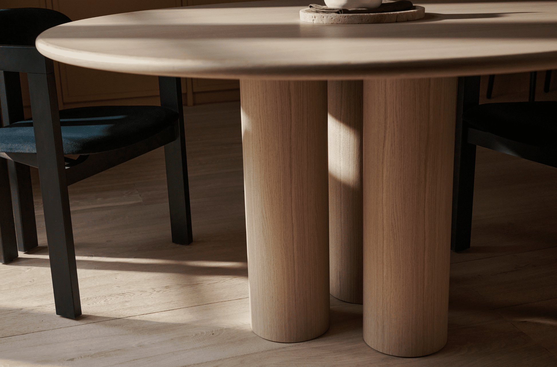 Round dining table with natural oak finish, FRANKY by My Store, showcasing smooth surface and sturdy wooden legs.