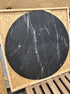 KIYO round dining table in Nero Marquina black marble with matte finish and minor scratches, 130 cm diameter.