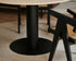 KIYO round dining table with Crema Marfil beige marble top, black center-leg, matte finish, 140 cm diameter.