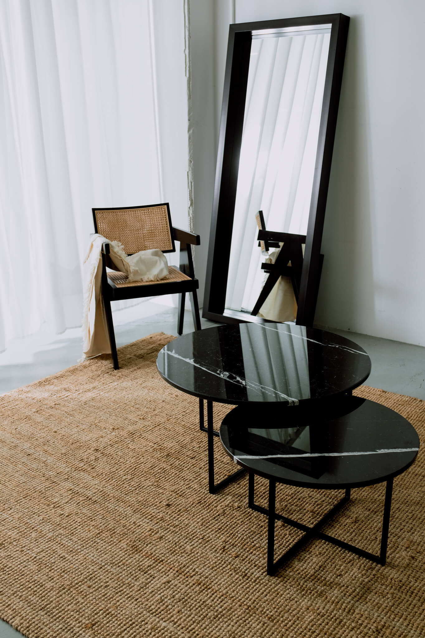 Matte black Nero Marquina marble round coffee table set with sleek, modern design and clean lines.