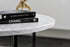 Round marble coffee table with Bianco Carrara white surface and light brown spots, featuring a matte finish and subtle scratches.