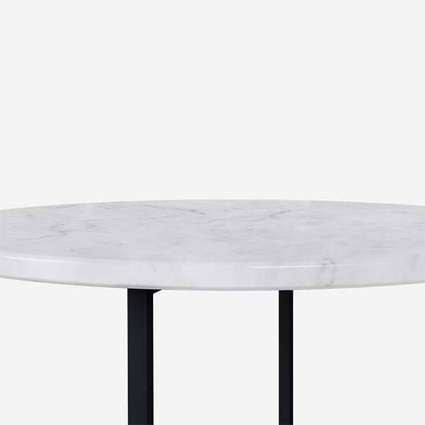 Round marble coffee table with Bianco Carrara white surface, matte finish, light brown spots, and subtle scratches.