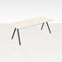 Rectangular oak dining table with ash white finish and V-frame design, showcasing a sleek, modern wood surface.