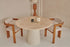 Flow round dining table with black travertine top and cylindrical base, stylish modern design for contemporary dining spaces.