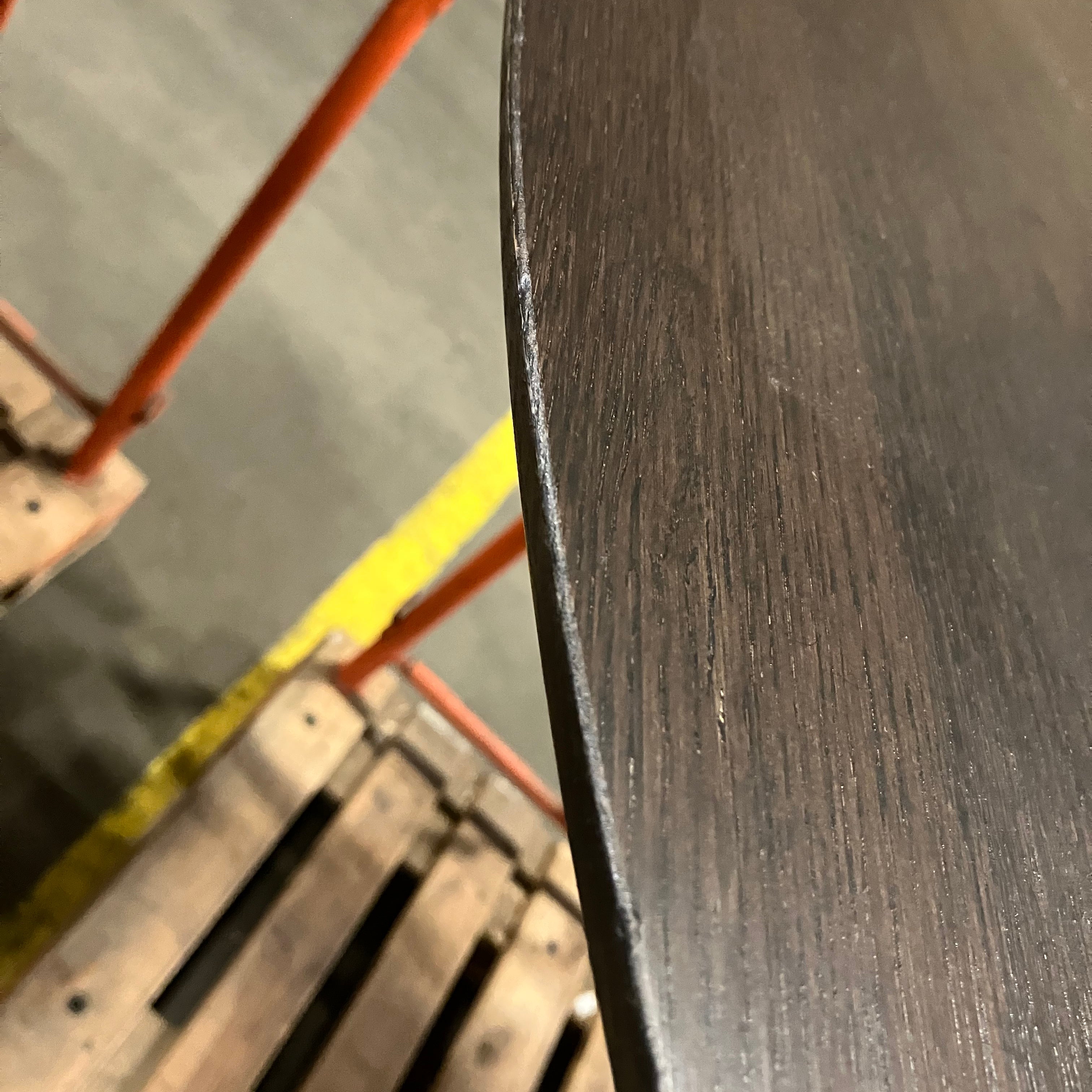 Flow round dining table in charcoal oak finish with subtle edge damage and small scratch, 140cm diameter, by My Store.