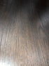 Flow round dining table in charcoal oak finish with edge damage and small scratch, 140cm diameter, by My Store.