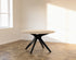 Round oak dining table with ash white finish and arched frame, showcasing a sleek circular design suitable for modern dining rooms.