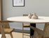 Round oak dining table with ash white finish and central leg, perfect for contemporary dining rooms.