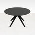 Round oak dining table with arched charcoal frame, showcasing the smooth wooden surface and modern design.
